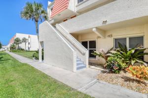 a house with a palm tree and a sidewalk at Pier Point 57 in St. Augustine