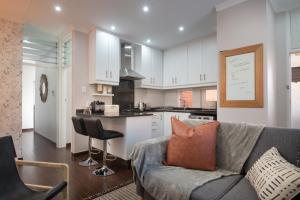 a living room with a couch and a kitchen at 903 Umdloti Resorts in Umdloti