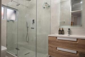 a bathroom with a shower with a glass shower stall at 903 Umdloti Resorts in Umdloti