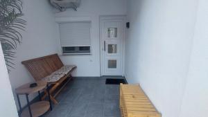 a hallway with a bench and a window and a door at Apartments Avia in Limenaria