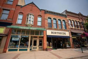 a large brick building on a street with a store at The Getaway in DT Northfield! in Northfield