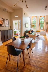 a living room with a table and chairs at The Getaway in DT Northfield! in Northfield +18 photos