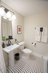 a white bathroom with a sink and a toilet at The Getaway in DT Northfield! in Northfield
