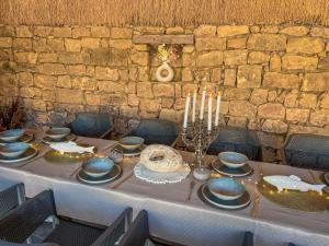 a table with blue dishes and candles on it at Pino - Villa, Casa, Cucina е Terrazza in Albena