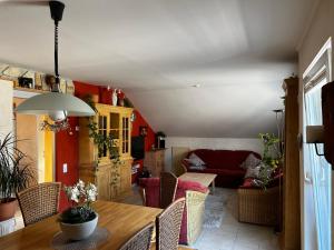 a living room with a table and a couch at Ferienwohnung Mediterran in Bad Driburg