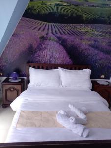 a bedroom with a bed with towels on it at Pensiunea Lina in Lepşa +3 photos