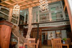 a dining room with a tree in the ceiling at Lucky Tuna in Unawatuna