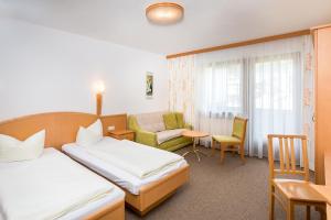 Rúm í herbergi á Hotel Grissemann