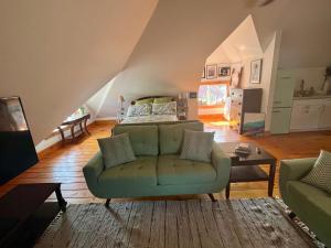 a living room with a couch and a bed at The Lakeview Loft in Port Colborne