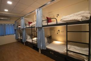 a group of bunk beds in a dorm room at Hostells - Backpacker Hostel near Pune Station in Pune
