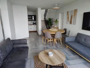 a living room with a couch and a table at Gordon's Bay Sunset View in Cape Town