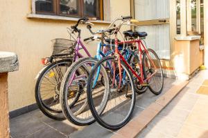 three bikes are parked next to a building at Villetta Girasole in Torre del Lago Puccini
