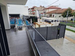 a balcony with a fence and a swimming pool at Aeonian Luxury Suites Asprovalta, Adults Only & Kids 12 Plus in Asprovalta