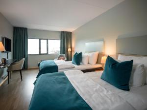 Postel nebo postele na pokoji v ubytování Quality Hotel Tønsberg