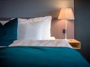 Postel nebo postele na pokoji v ubytování Quality Hotel Tønsberg
