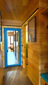 a room with a blue door and wooden walls at Hostdomus - Copenaghen Suite in Sestriere +26 photos