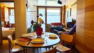 a dining room with a table with a vase on it at Hostdomus - Copenaghen Suite in Sestriere