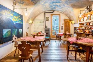 a dining room with tables and a painting on the ceiling at Agritur Solasna in Caldes