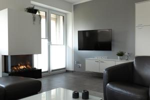 TV a/nebo společenská místnost v ubytování watn Meerblick-Nordseepark Dangast, 2Schlafzimmer,2Bäder,Kamin,Parkplatz