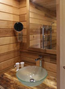 a bathroom with a sink in a wooden wall at Chalet Pesse in Manigod +6 photos