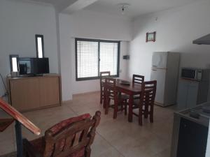 a kitchen and dining room with a table and chairs at Don Jose in Piquete