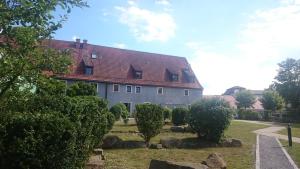 a large white house with a red roof at Apartment Regensburg in Regensburg