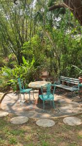 una mesa de picnic, 2 sillas y un banco en Paradiso, en Port Shepstone