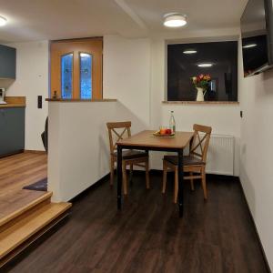 a dining room and kitchen with a table and chairs at Ferienwohnung Kretschmar in Oberammergau +4 photos