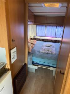 a small room with a bed inside of a trailer at Jacuzi Cottage in the olive grove in Pula +65 photos
