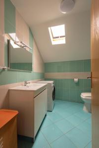 a bathroom with a sink and a washing machine at Casa Amarela - Serra da Estrela Portugal in Verdelhos +16 photos
