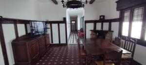 a dining room with a table and a television in it at Maui Hostel in Mar del Plata