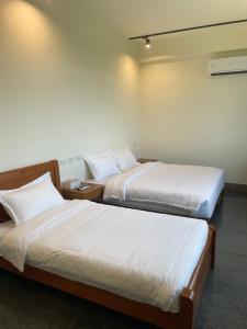 Voodi või voodid majutusasutuse 金門民宿 獺上小島民宿 文旅 青旅 toas