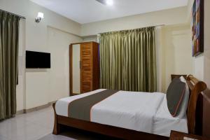 a bedroom with a bed and a television in it at Hotel O Grandeur in Méribel Village