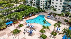 an aerial view of a swimming pool at a hotel at Beachside Bliss: 1BR Retreat Amenities in Sunny Isles Beach