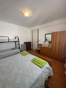 a bedroom with two bunk beds and a mirror at La Perla del Dolcedorme in San Lorenzo Bellizzi +16 photos
