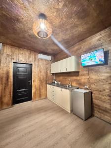 a kitchen with a sink and a black door at Hovakimyans Hotel And Pool 24 & 7 in Pʼarakʼar