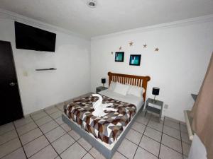 a bedroom with a bed with a dog on it at Chi Ibal Hu Cancun in Cancún