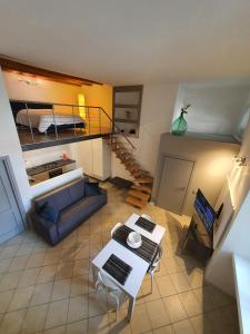 a view of a living room with a couch and a staircase at Casa Bortolin in Domodossola