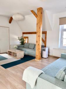 a living room with a couch and a table at Przestronny apartament nr 7 z widokiem na góry Sowie in Bielawa