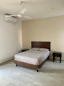 a bedroom with a bed and a ceiling fan at Excelente Departamento en planta baja colonia Altabrisa in Mérida
