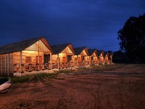 a row of lodges lit up at night at Hampi One Love in Hampi