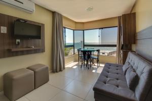 a living room with a couch and a table at Flat Pietra in Florianópolis
