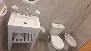 a bathroom with a white sink and a toilet at La casa, alquiler temporario - casa completa con cochera y patio- parrilla in Villa Mercedes +38 photos