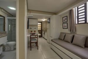 a living room with a couch and a table at Flat Pietra in Florianópolis