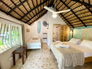 a bedroom with two beds and a window at Surfbreak Cabarete in Cabarete +58 photos