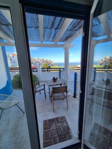 a view of a patio with a table and chairs at Villa Alegria in Ericeira