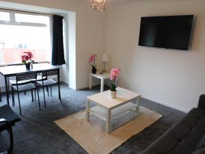 a living room with a couch and a table at No 52 - Newly refurbished 3 bedroom home in East Kilbride in East Kilbride