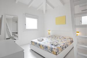 a white bedroom with a bed with teddy bears on it at Porto Cervo Cala Del Faro, Villetta con Giardino e Rooftop in Cala Del Faro