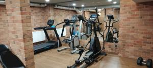 a gym with several exercise bikes in a brick wall at Uroczy Apartament Długie Ogrody 48 in Gdańsk