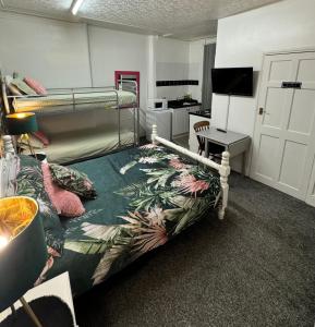 a bedroom with a bed and a desk with a computer at On The Beach Apartments in Blackpool